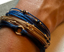 Load image into Gallery viewer, 14k yellow gold featured in navy; paired with 14k gold Pleiades in champagne and 14k gold Chronos (trea) in blue