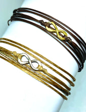 Load image into Gallery viewer, Yellow gold vermeil featured in chocolate (original) (top) and sterling silver featured in champagne (original with sparkly cord) (bottom)