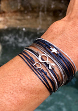 Load image into Gallery viewer, Paired together: Horseshoe in navy, Silverfish in taupe, Star in navy - all with silver sparkly cord