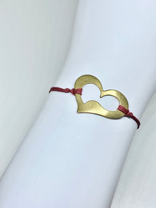 Brass heart featured in crimson
