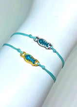 Load image into Gallery viewer, Zamak featured in aquamarine (top) and yellow gold plated zamak featured in aquamarine (bottom)