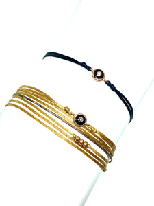 Rose gold vermeil with black enamel featured in black (mona) (top) and rose gold vermeil with black enamel featured in champagne (original with sparkly cord) (bottom)