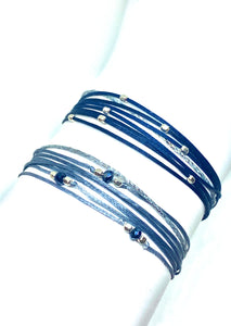 Sterling silver  (trea( featured in gray with sparkly cord (bottom); paired with sterling silver Pleiades featured in navy